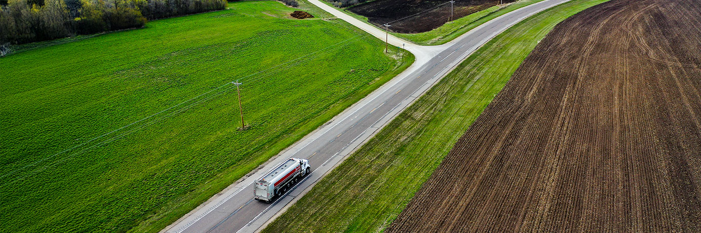 Aerial view of a truck driving down a country road