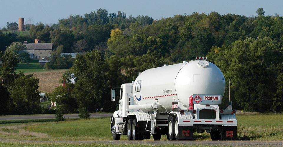 CHS propane truck driving down a country road