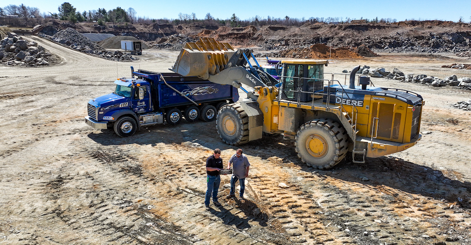 Dumping dirt into a dump truck