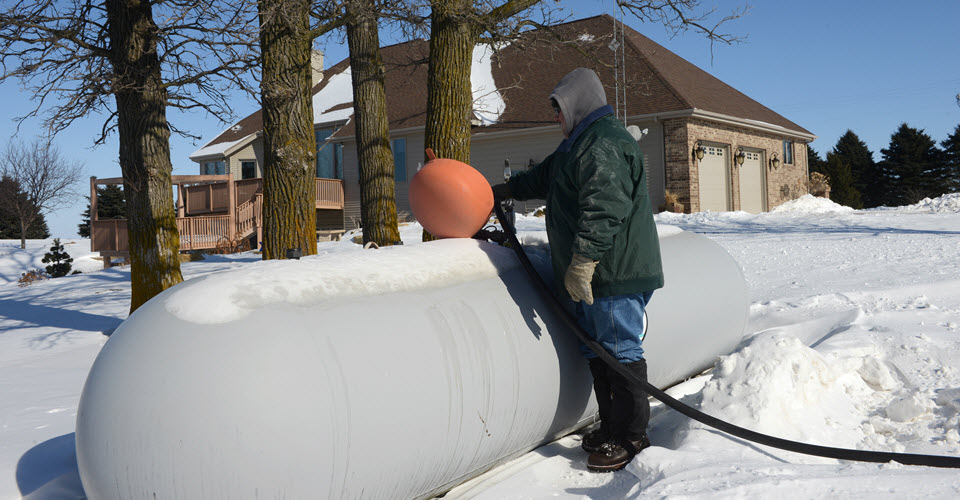Filling a propane tank in the snow