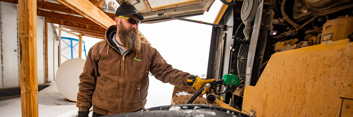 Man filling gas in a tractor