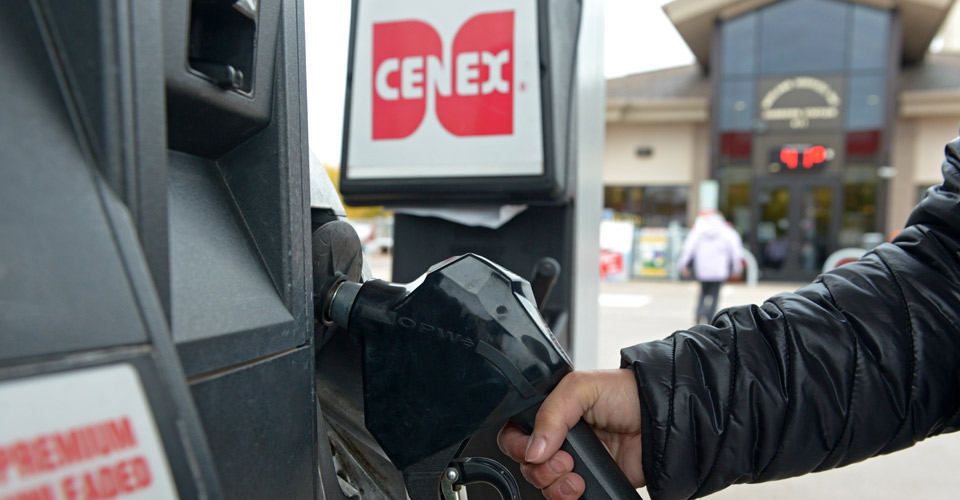 Reaching for the nozzle at a Cenex gas pump