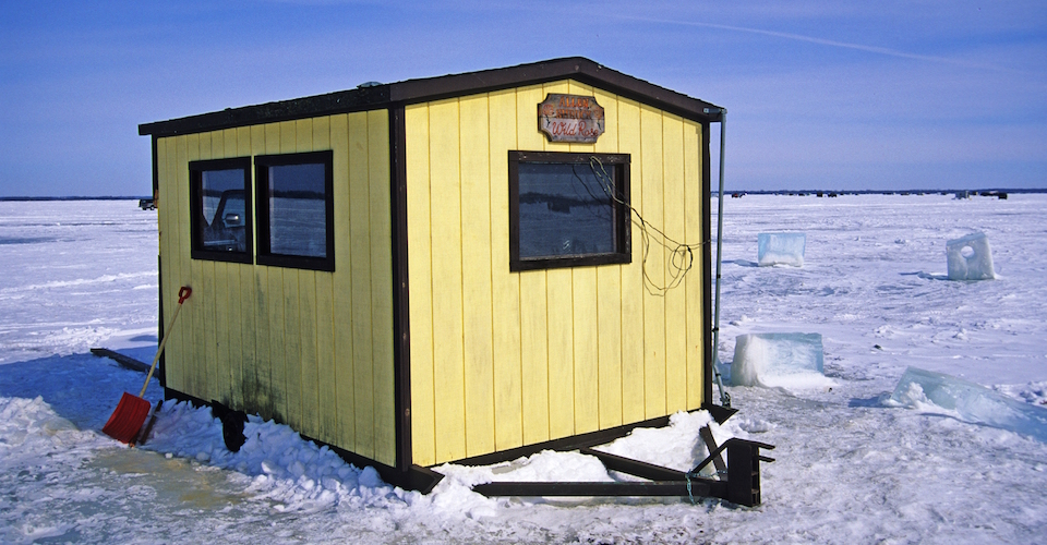 Ice shack on the frozen lake