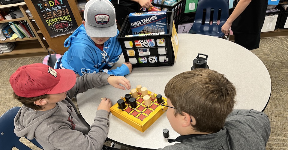 Three kids playing a game together