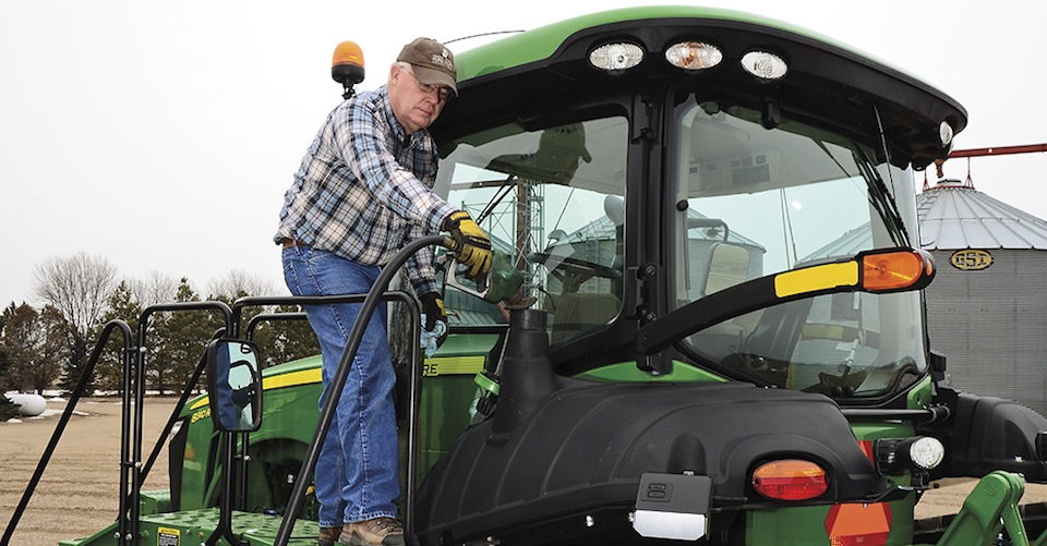 Man getting onto a tractor