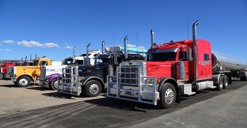 Semi trucks parked in a lot