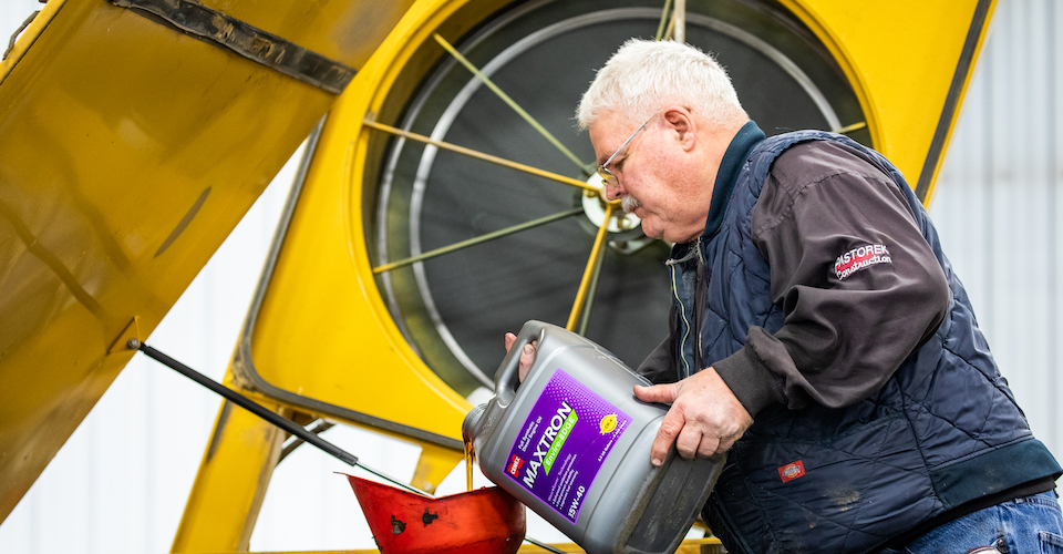 Pouring Maxtron Enviro-Edge into an engine