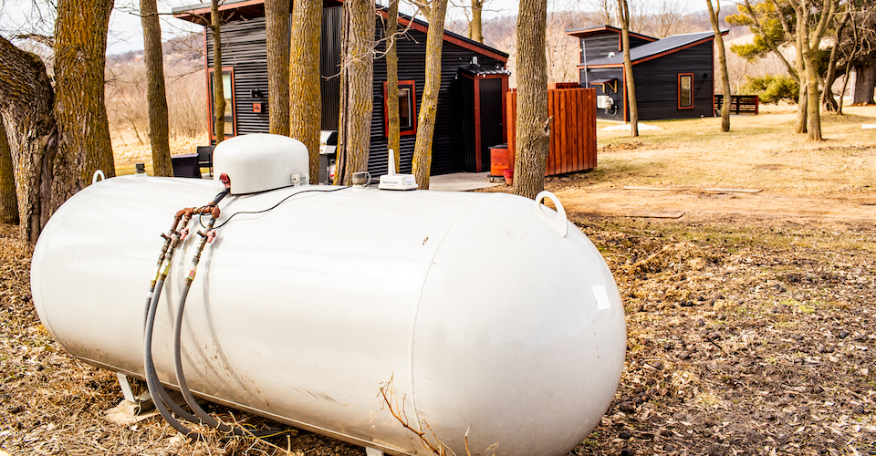 Propane tank in front of cabins