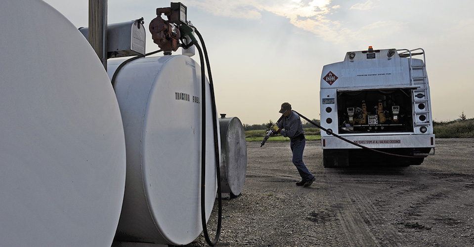 Man filling truck with fuel.