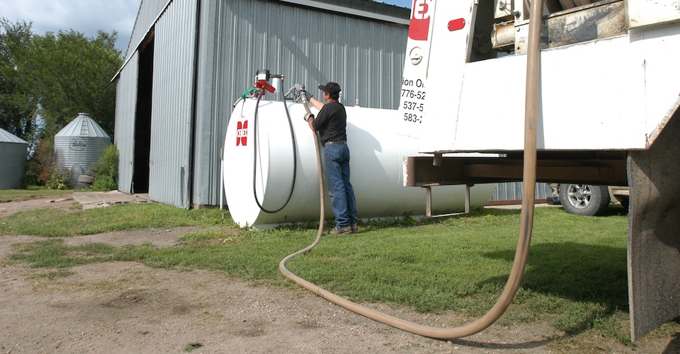 Hooking up a hose to fill propane from a truck to the farm tank