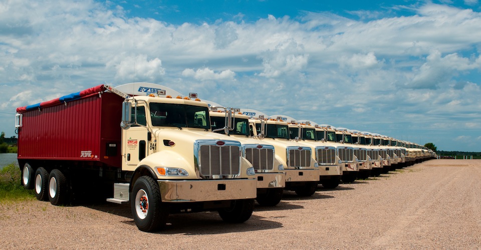 A long row of dump trucks