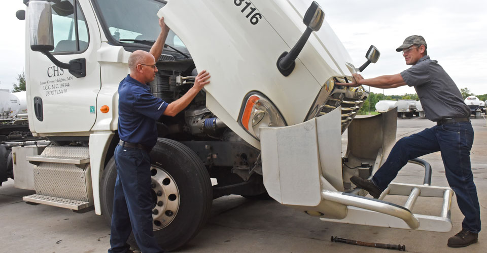 Checking under the hood of a CHS semi cab