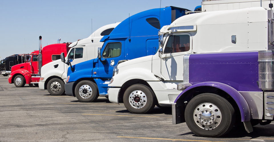 Semi trucks parked in front of each other