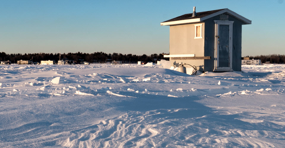Small building surrounded by snow