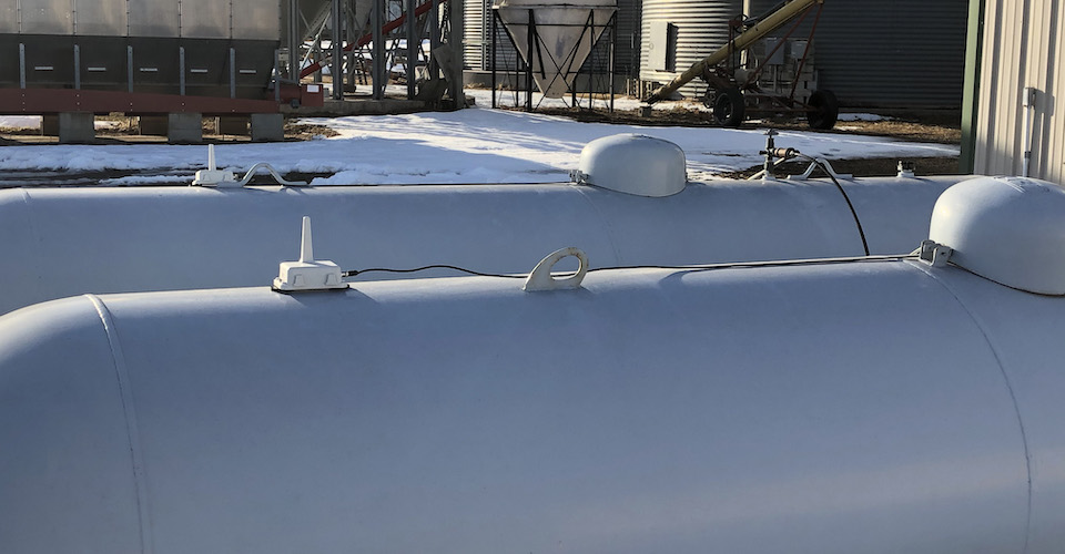 Two tanks in front of a barn