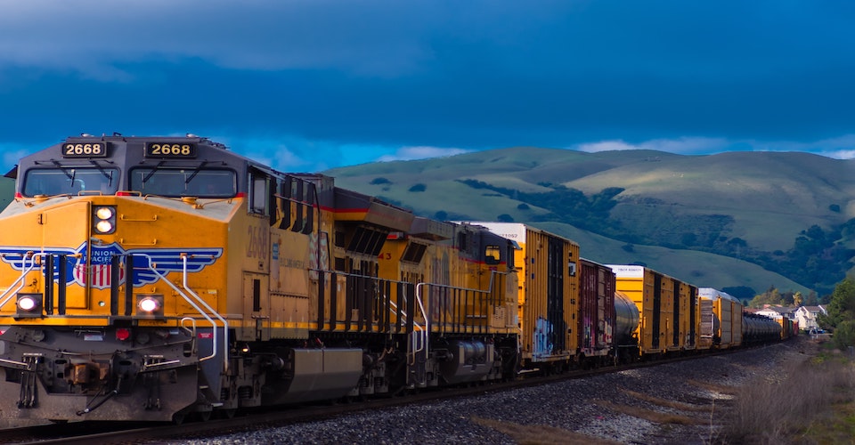 Train driving away from the mountains