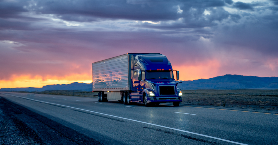 Truck driving in the sunset
