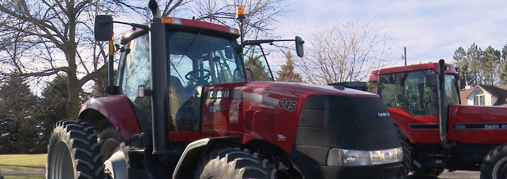 Two tractors parked next to each other