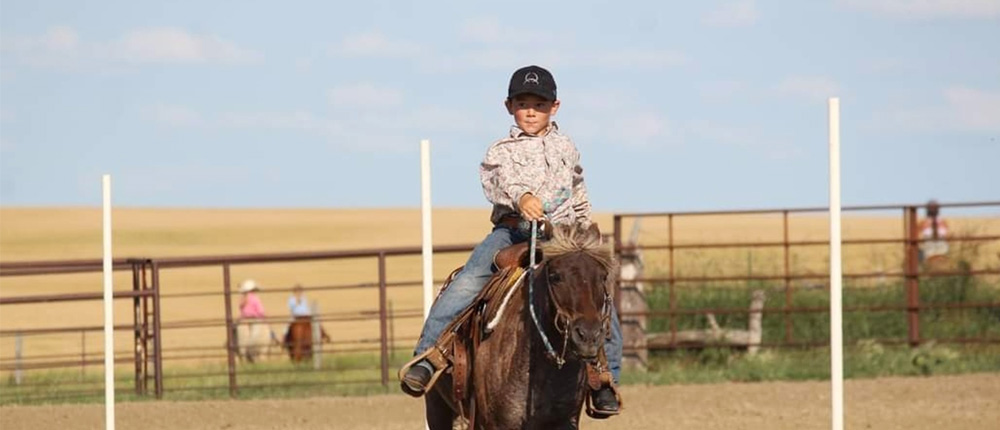 Boy riding in a youth rodeo