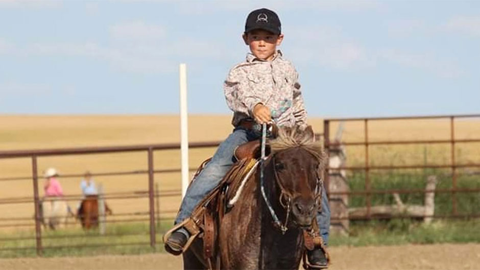 Boy riding in a youth rodeo