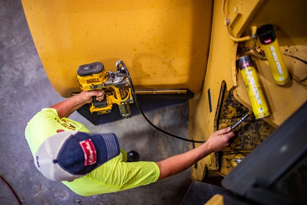 Man with tool, checking out equipment