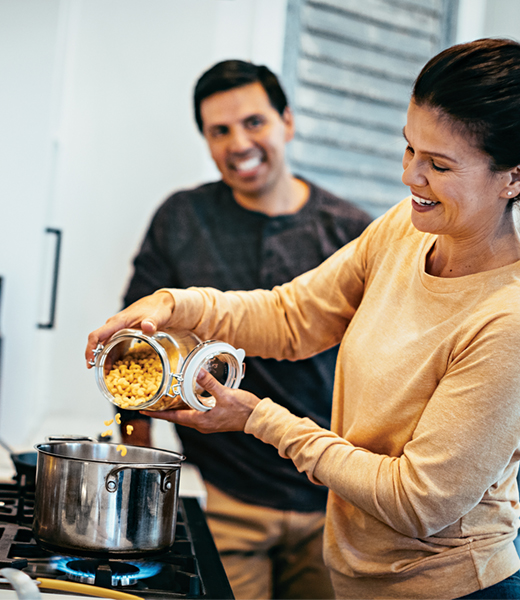 a-woman-pouring-food-to-cook-into-a-pot_Ratio_2_6-3